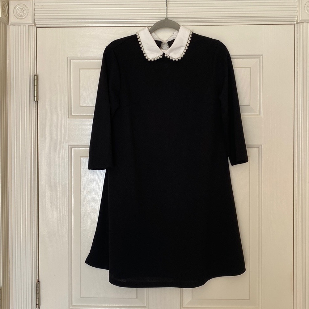 Black and white boutique dress with pearl neckline. Never worn! Size medium.